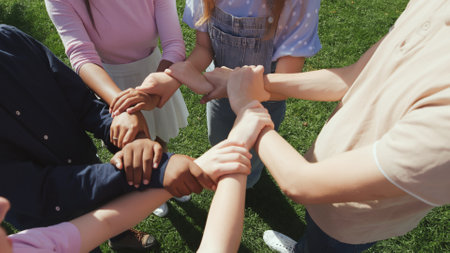 Cropped shot of diverse students make circle with hands outdoorsの写真素材