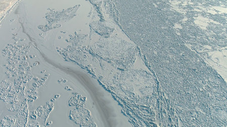 Aerial top view of ice on frozen river