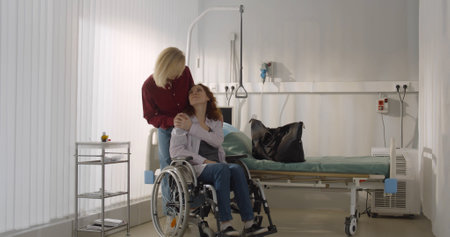 Senior woman pushing wheelchair with daughter discharged from hospitalの写真素材