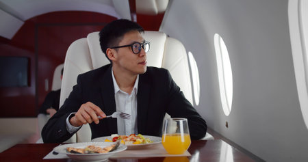 Asian businessman having lunch flying first class.の写真素材