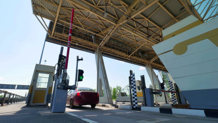 Cars at modern toll road turnpike with traffic