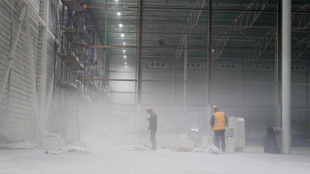 Workers on scaffolding inside large and modern warehouseの写真素材