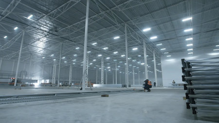 Builders working in modern industry warehouseの写真素材