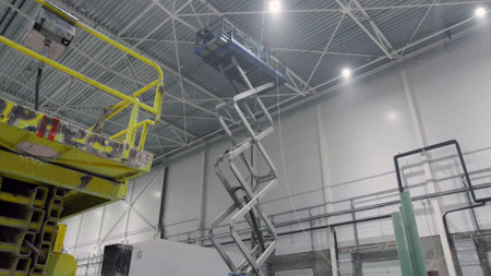 Industrial lift with welder inside warehouseの写真素材