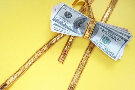 Very expensive gift - a heap of money tied up by a ribbonの写真素材