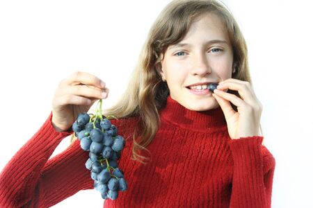 The nice girl wishes to eat juicy grapesの写真素材