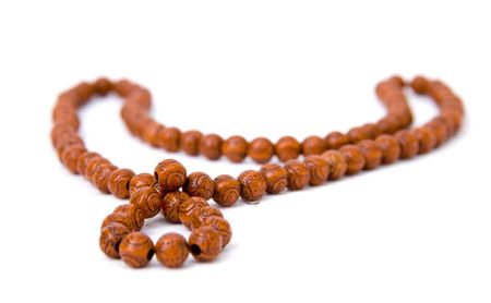 The wooden necklace with the Chinese hieroglyphs hangs down from a clothの写真素材