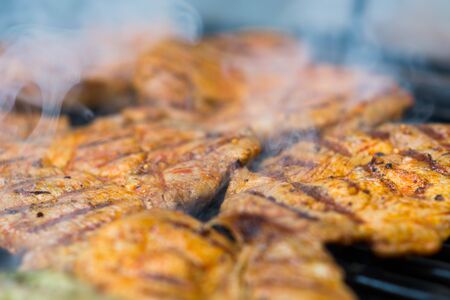 Chicken breast being prepared on grillの写真素材