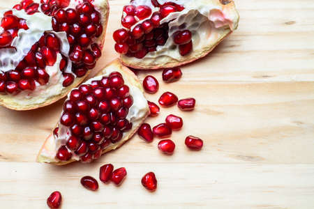 Pomegranate on a table with seedsの写真素材