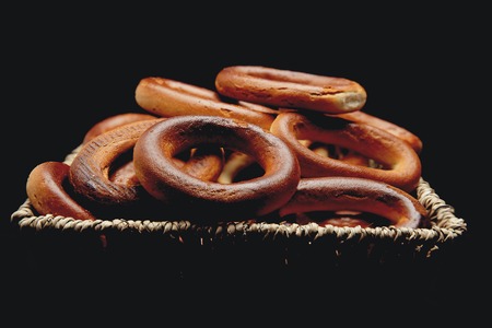 Basket full with bagels on dark backgroundの写真素材