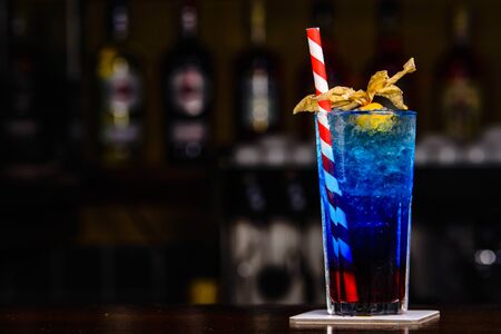 Blue cocktail on the bar tender. Cocktail served.の写真素材
