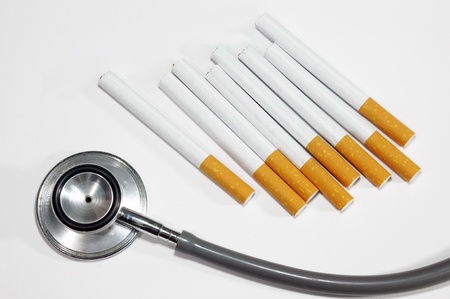 cigarette and stethoscope on white backgroundの写真素材