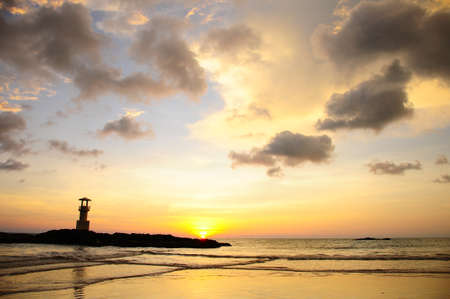 lighthouse in sunset and cloudsの写真素材