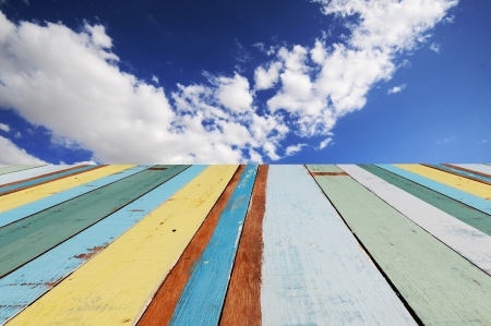 colorful wooden boards with blue sky and clouds の写真素材
