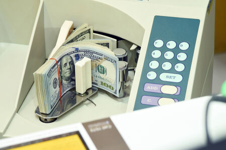 100 US dollar money in counting machineの写真素材