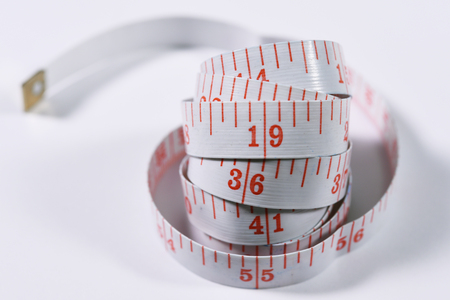 White measure tape isolated on white background.