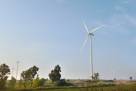 wind turbine against cloudy blue sky backgroundの写真素材