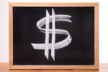 Dollar sign on a blackboard.