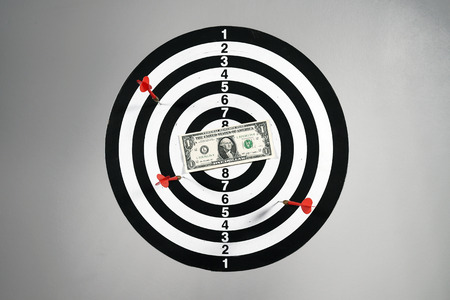 One dollar bill on a dartboard.の写真素材
