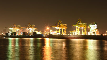 BANGKOK, February 26,2015: Port Authority of Thailand Klongtoey. The biggest port in Bangkok with loaded freight ship and cargo handling equipment on the side of Chao Phraya river. Bangkok,Thailand.のeditorial素材