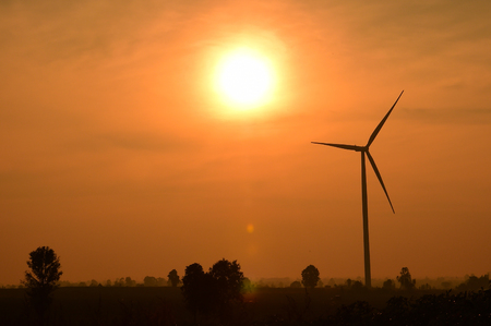 Wind turbines silhouette at sunset.の写真素材