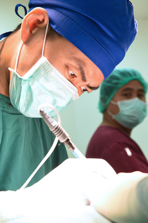 two veterinarian surgeons in operating roomの写真素材