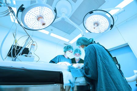 group of veterinarian surgery in operation room take with art lighting and blue filterの写真素材