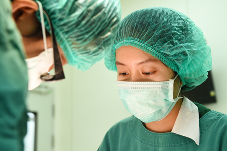 two veterinarian surgeons in operating roomの写真素材