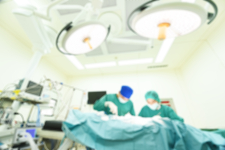 Blur of two veterinarian surgeons in operating roomの写真素材