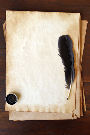 old paper with feather and ink on wooden backgroundの写真素材