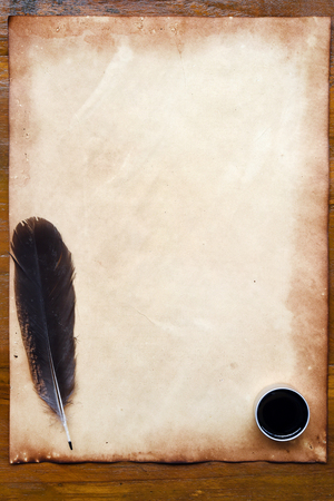 old paper with feather and ink on wooden backgroundの写真素材