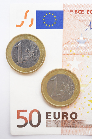 Fifty Euro and coin isolated on white backgroundの写真素材