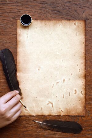old paper with feather and ink on wooden backgroundの写真素材
