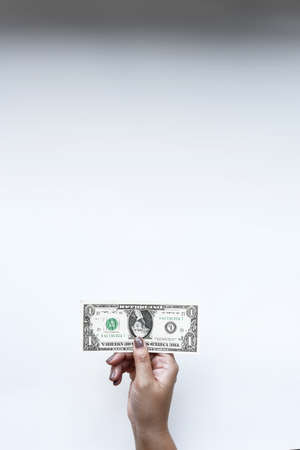 Dollars bill on hand isolated on white backgroundの写真素材