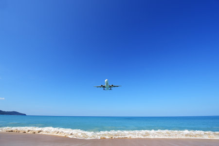 PHUKET, THAILAND - NOVEMBER 17 : The airplane landing at Phuket airport over the Mai Khao Beach on November17, 2016 in Phuket, Thailand.のeditorial素材