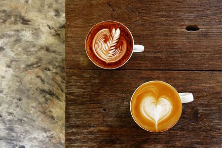 cup of latte art coffee on wooden backgroundの写真素材
