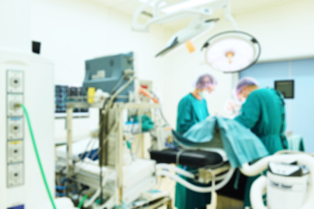 Blur of two veterinarian surgeons in operating roomの写真素材