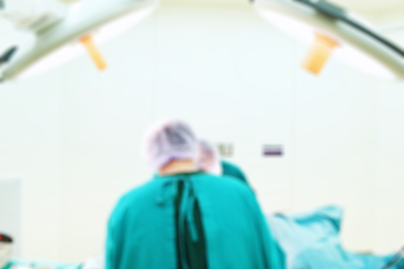 Blur of two veterinarian surgeons in operating roomの写真素材