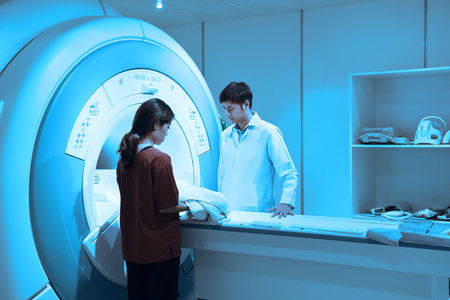 veterinarian doctor working in MRI scanner room take with art lighting and blue filterの写真素材