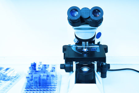 close up shot of microscope at the blood laboratory take with art lighting and blue filter