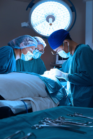 group of veterinarian surgery in operation room take with art lighting and blue filterの写真素材