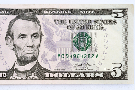 close up of banknote on hand isolated on white background