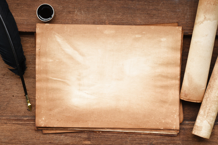 old paper on brown wood texture with feather and ink for backgroundの写真素材