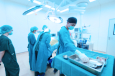 Blur of group of veterinarian surgery in operation room take with art lighting and blue filterの写真素材