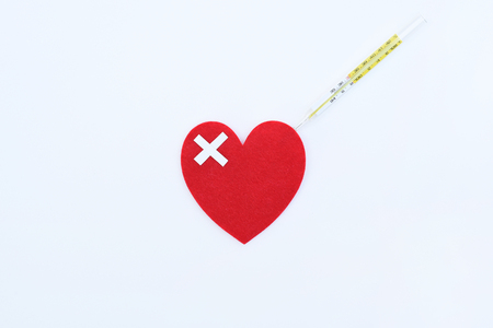 Red heart and thermometer isolated on white backgroundの写真素材