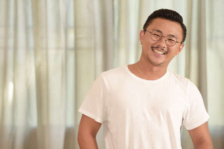 Portrait of young man smiling laughing looking at cameraの写真素材