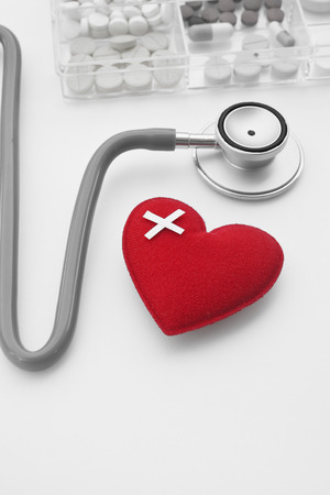 Red heart with stethoscope isolated on white background take with selective color technique and art lightingの写真素材
