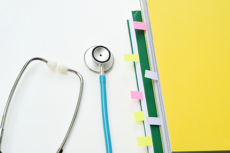 close up of stethoscope with notebook for backgroundの写真素材