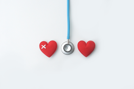 Red heart with stethoscope isolated on white backgroundの写真素材