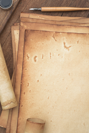 old paper on brown wood texture with pen and ink.の写真素材